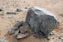 Shattered stone surfaces at Chephren's quarry, Old Kingdom. Firesetting used to peel the block making it suitable for further work with hammerstones to create a sculpture. Photo: Per Storemyr